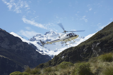 Fototapeta na wymiar Low angle view of helicopter over mountains