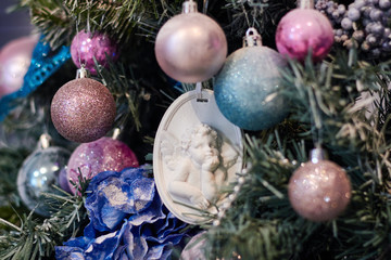 Beautiful Christmas decor, New year toys, glow in the dark garland. Christmas tree decorated with toys and balloons. Festive mood before Christmas eve. The house is decorated before the holiday