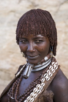 Portrait of a woman of the Hamer tribe, her hair treated with ochre, water and resin and twisted into tresses known as goscha, Lower Omo Valley, Southern Ethiopia