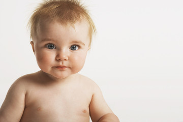 Closeup portrait of cute baby with ginger hair isolated on white background
