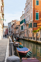 Fototapeta na wymiar boats and gondolas in canal of Venice city