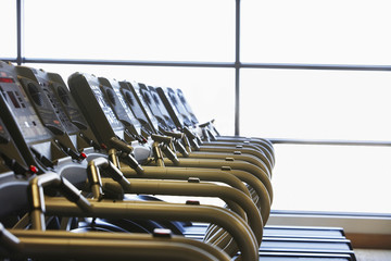 Fototapeta premium Gym with windows and row of running machines
