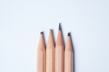 A sharpen pencil among blunt pencils on white background, present idea of smart and intelligent.