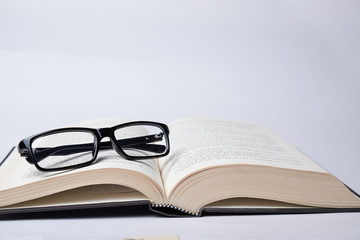 Eyeglasses on the open book. Idea of happy reading a noval and education.