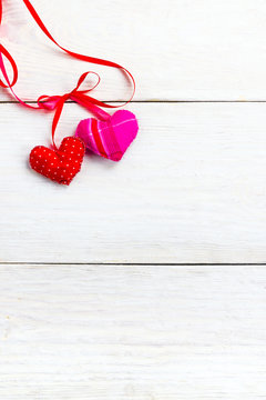background for Valentine's Day greetings, sewn from various fabrics soft hearts on a wooden background