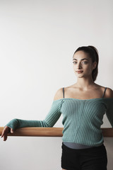 Fototapeta premium Portrait of beautiful young woman relaxing at ballet bar