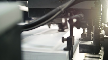 Printed sheets of paper are served in the printing press. Offset , CMYK, close up