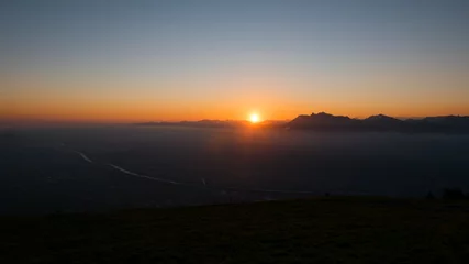 Fotobehang Sonnenaufgang über Bergkette mit klarem Himmel © liamalexcolman