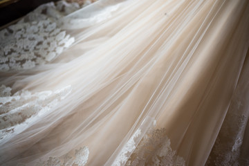 Fototapeta na wymiar bridesmaid tying bow on wedding dress