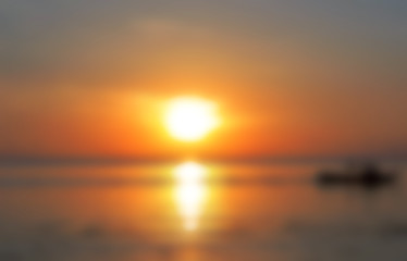 Blurred tropical sea view. Beautiful orange sunset by seaside blurred photo