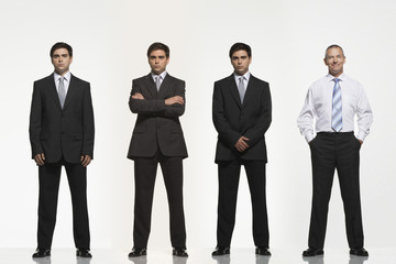 Full length portrait of businessmen standing side by side against white background
