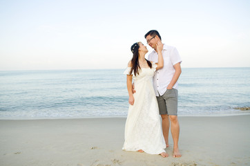 Outdoor Bride and groom on the beach  in the evening.