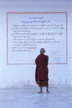 Monk reading Burmese wall script, Shwedagon, Yangon (Rangoon)
