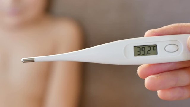 Mother measurement temperature his son
