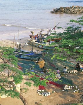 Fishermen mending their nets in the fishing harbour at Galle, Sri Lanka