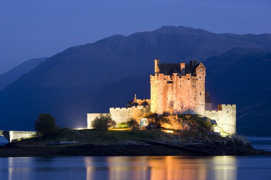Eilean Donan Castle floodlit at night on Loch Duich, near Kyle of Lochalsh, Highland, Scotland