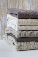 Stack of warm knitted sweaters