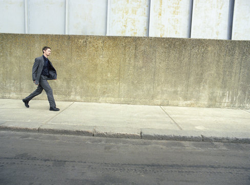 Full length of business man walking on sidewalk