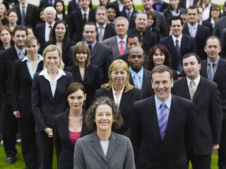 Portrait of a confident businesswoman with multiethnic team