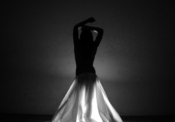 Female nude body in a dark.