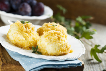 Cottage cheese and potato dough dumplings with plums