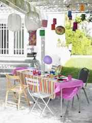 Outdoor table and decorated patio after birthday party