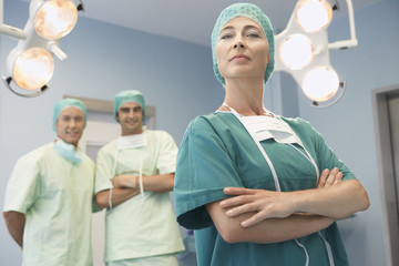 Head of surgical team with surgeons in operating theatre