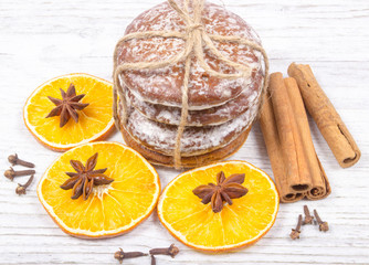 Gingerbread cookies, cinnamon and orange slices. Christmas decoration.