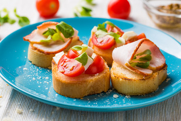 Bruschetta with tomato, cheese and bacon