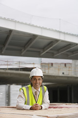 Portrait of a smiling male construction worker at building site