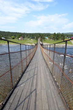 Suspension bridge over a mountain river in the Altay.