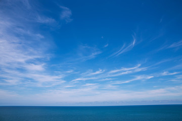 Obraz premium Clouds, blue sky, calm sea. And skyline