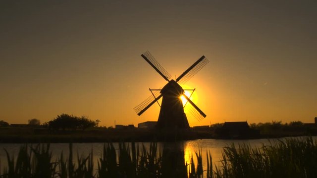 Aerial amazing old traditional Dutch windmill at beautiful golden sunset 