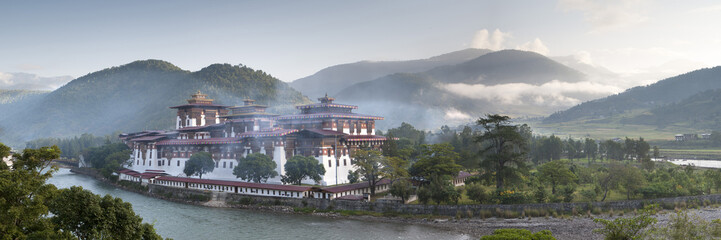Misty dawn view of the Punakha Dzong located at the junction of the Mo Chhu (Mother River) and Pho Chhu (Father River) in the Punakha Valley, Bhutan, Himalayas