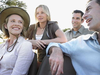 Group of happy four tourists on safari sitting in jeep © MDBPIXS