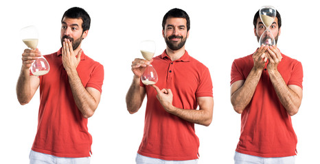 Handsome man holding a vintage sand clock