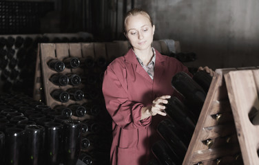 Laughing woman winery employee working in cellar