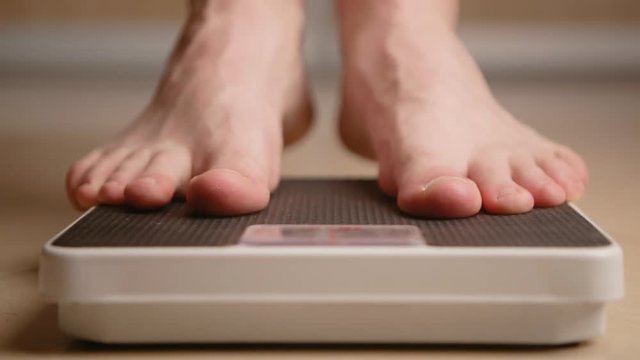 man standing on weight scale