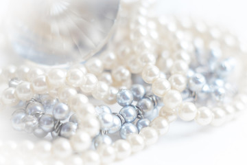 Abstract blurred background, pearl necklace on white. Macro shot, Shallow depth of field, defocused