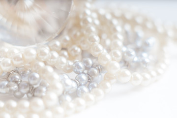 Abstract blurred background, pearl necklace on white. Macro shot, Shallow depth of field, defocused