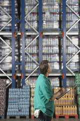 Young warehouse worker checking inventory