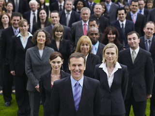 Portrait of a confident businessman with multiethnic team
