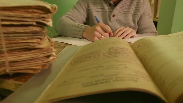 Man looking documents in the archive.