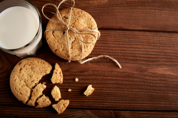 Cookies and milk. Chocolate chip cookies and a glass of milk. Vintage look. Tasty cookies and glass of milk on rustic wooden background. Food, junk-food, culinary, baking and eating concept