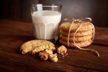 Cookies and milk. Chocolate chip cookies and a glass of milk. Vintage look. Tasty cookies and glass of milk on rustic wooden background. Food, junk-food, culinary, baking and eating concept