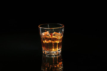 Glass of whisky on dark background