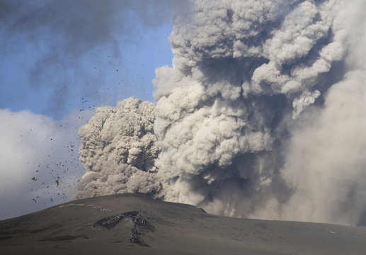 Eyjafjallajokull eruption showing billowing ash plume and rocks exploding into the sky of southern Iceland, Iceland