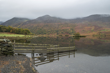 Beautiful Autumn Fall landscape image of Crummock Water at sunri