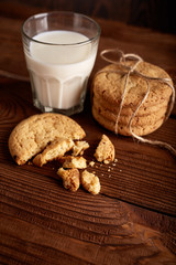 Cookies and milk. Chocolate chip cookies and a glass of milk. Vintage look. Tasty cookies and glass of milk on rustic wooden background. Food, junk-food, culinary, baking and eating concept