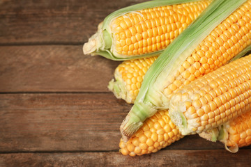 Corncobs on wooden rustic table, closeup